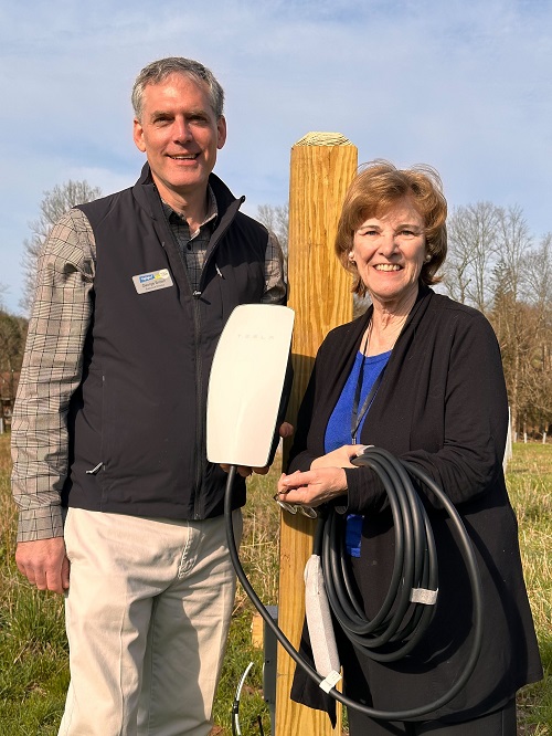 Photo of Geroge Brown with Marilyn Mallue, who helped support the EV charger project.