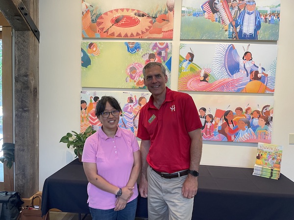 Nancy Miller with George Brown in front of the Art Wall